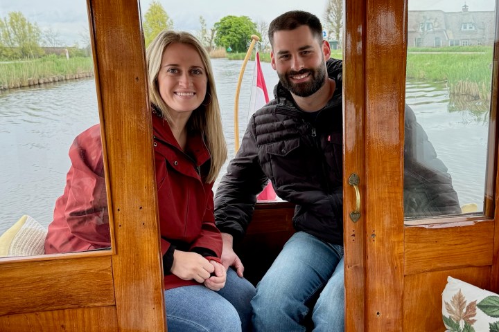 a woman sitting on a bench next to a window